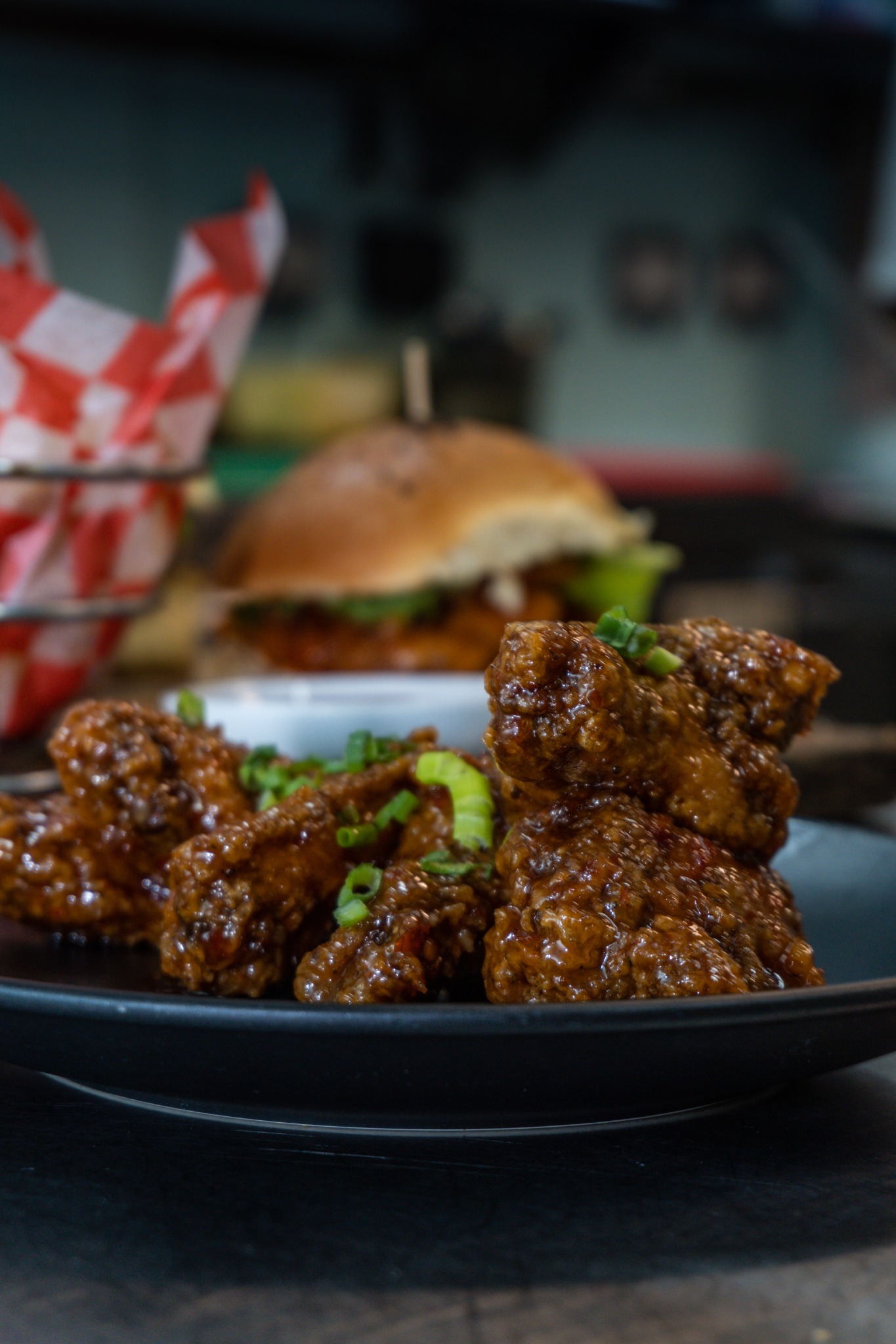 Burger and wings plated for a menu shoot